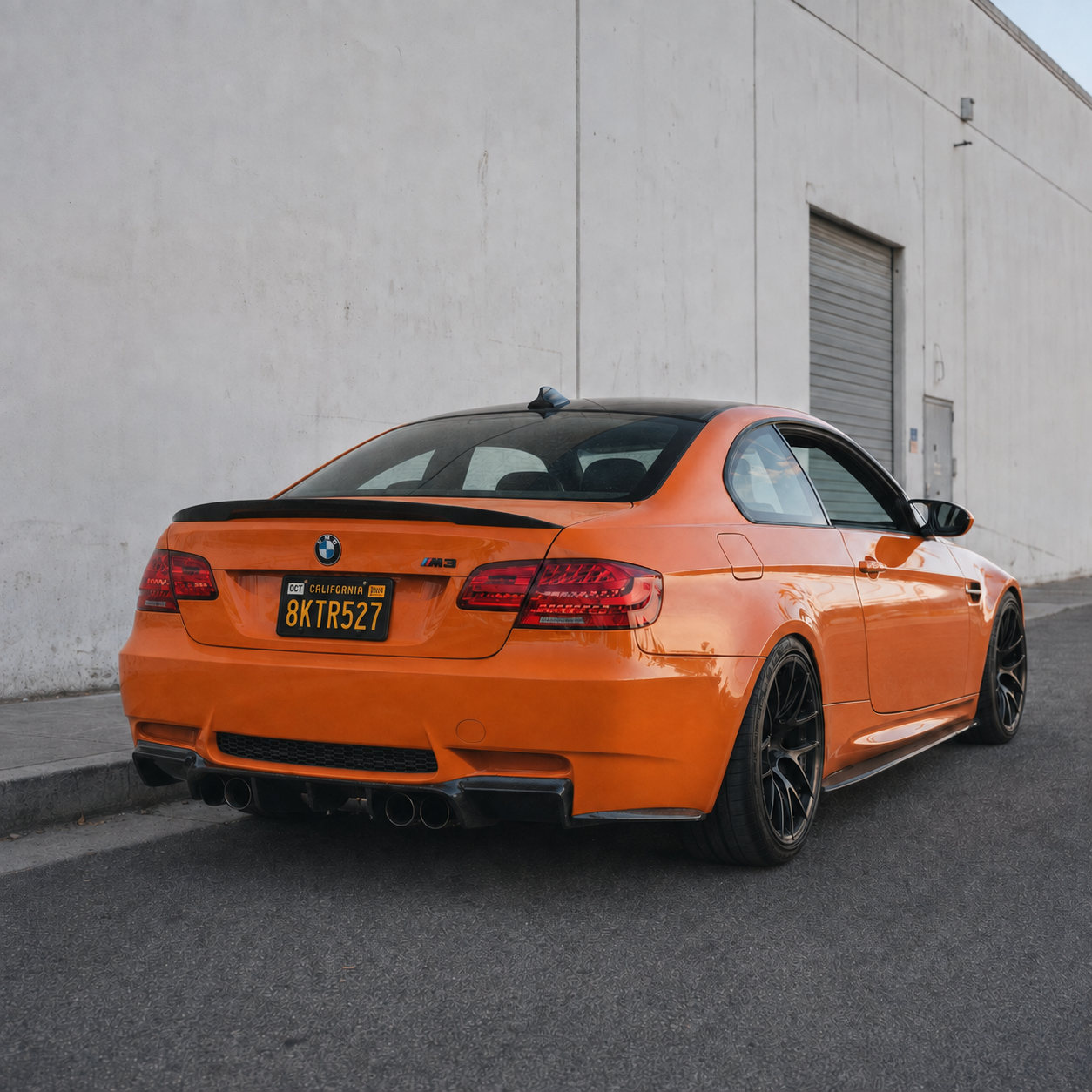 AlpineX Dynamics V Style Carbon Fiber Rear Diffuser installed on a BMW E92 M3, featuring a glossy carbon fiber finish and an aggressive rear-end design.