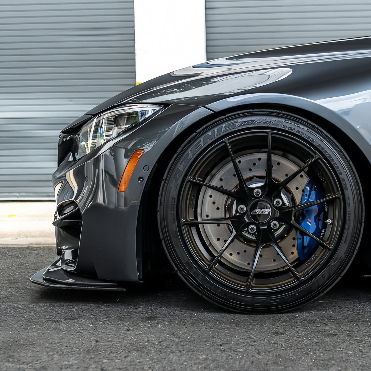 Side view of a gray BMW F82 M4 with chassis-mounted GTS-style carbon fiber front splitter