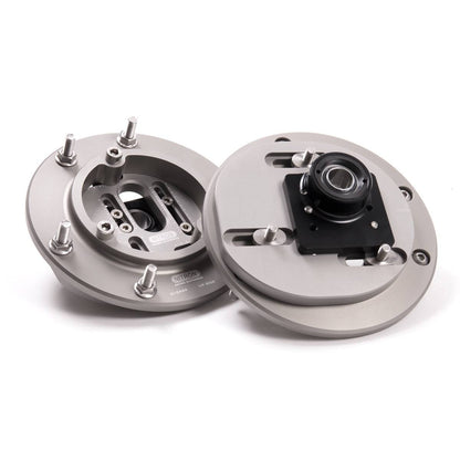 Nitron top mounts showing the adjustment face and underside bearing; generic product illustration