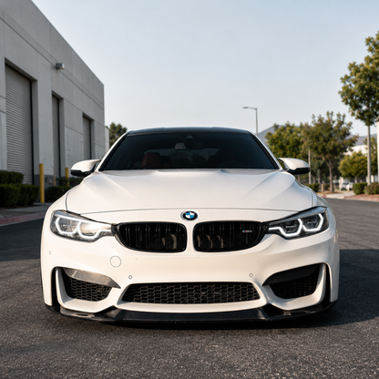 AlpineX Dynamics CS Style Carbon Fiber Front Lip installed on a white BMW F8X M3/M4, shown from the front.