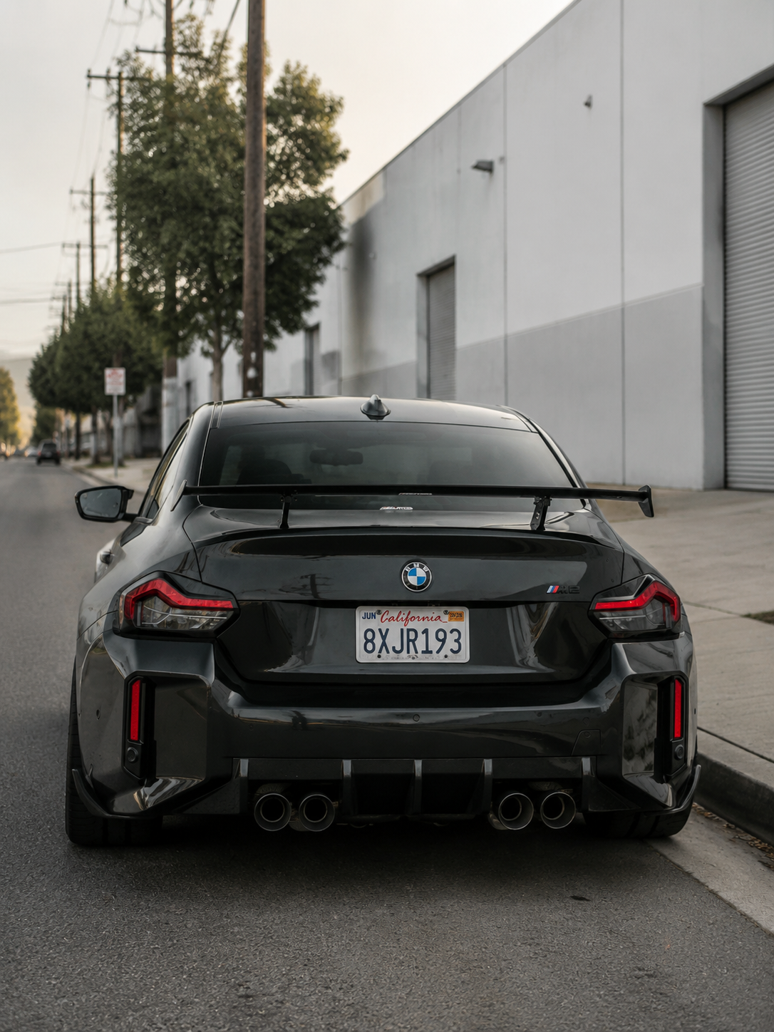 AlpineX Dynamics MP Style Carbon Fiber Rear Diffuser installed on a BMW G87 M2, enhancing the rear-end styling with a lightweight carbon fiber aerodynamic upgrade and aggressive motorsport-inspired design.