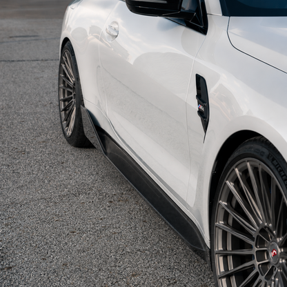AlpineX Dynamics MP Style Carbon Fiber Side Skirt installed on a BMW G80 M3, featuring a glossy carbon fiber finish and an aggressive OEM-inspired side profile enhancement.