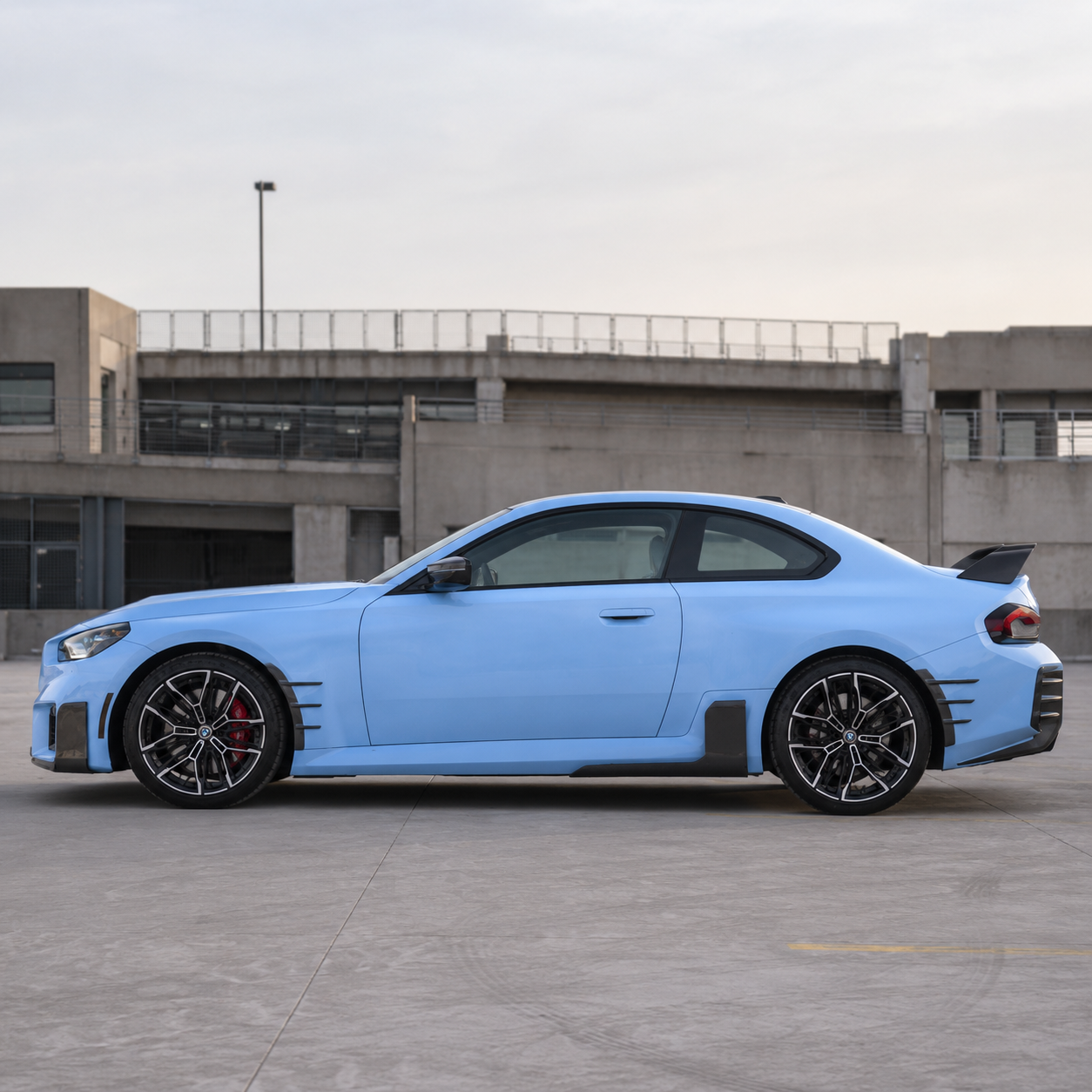 AlpineX Dynamics MP Style Carbon Fiber Side Skirt installed on a BMW G87 M2, enhancing the vehicle’s side profile with a lightweight carbon fiber aerodynamic upgrade and aggressive motorsport-inspired styling.