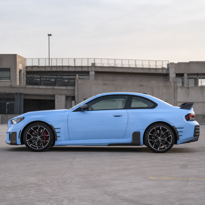 AlpineX Dynamics MP Style Carbon Fiber Side Skirt installed on a BMW G87 M2, enhancing the vehicle’s side profile with a lightweight carbon fiber aerodynamic upgrade and aggressive motorsport-inspired styling.