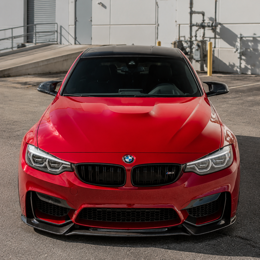 AlpineX Dynamics Varis Style Carbon Fiber Front Lip installed on BMW F8X M3 M4 showcasing an aggressive aerodynamic upgrade and enhanced front-end styling.
