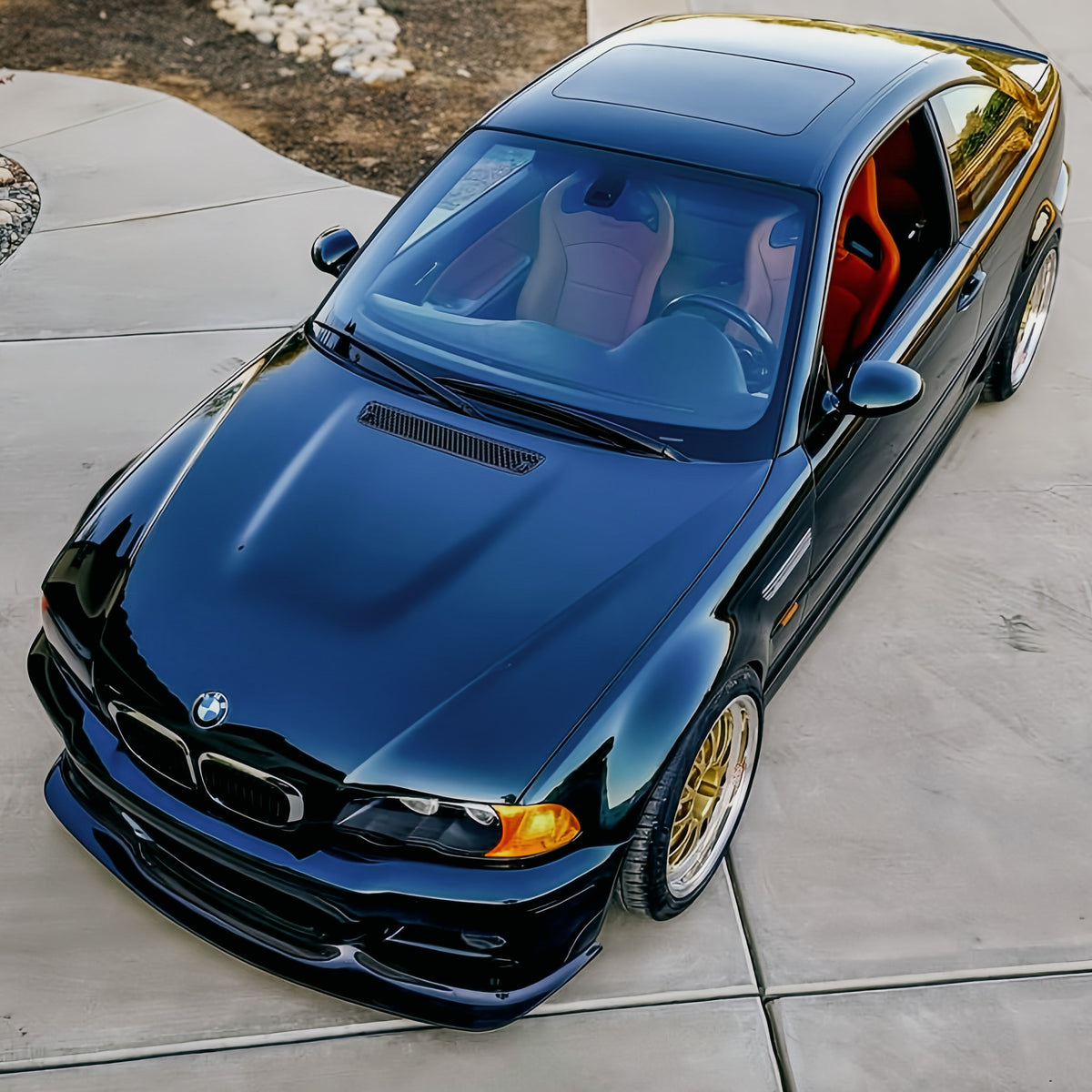 Overhead front view of black BMW E46 M3 with GT4 carbon fiber front lip