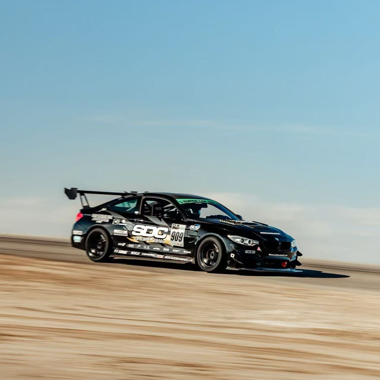 Black BMW F8X Time Attack car running the GT4+ aero system with rear wing and splitter and front bumper canards