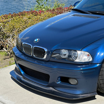 Close-up of blue BMW E46 M3 with extended GT4 carbon fiber front lip