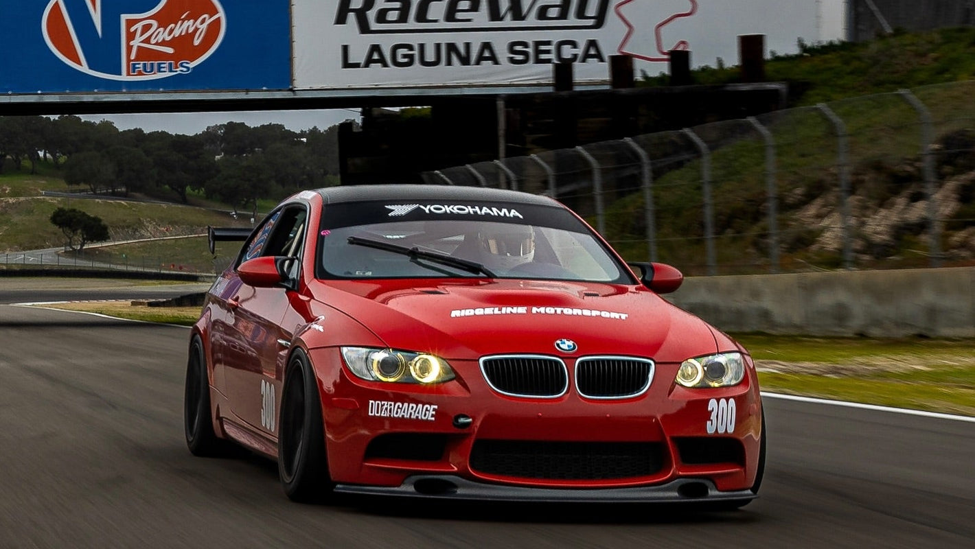 Red BMW E92 M3 GT4 Clubsport build with Ridgeline Motorsport front splitter and rear wing at Laguna Seca