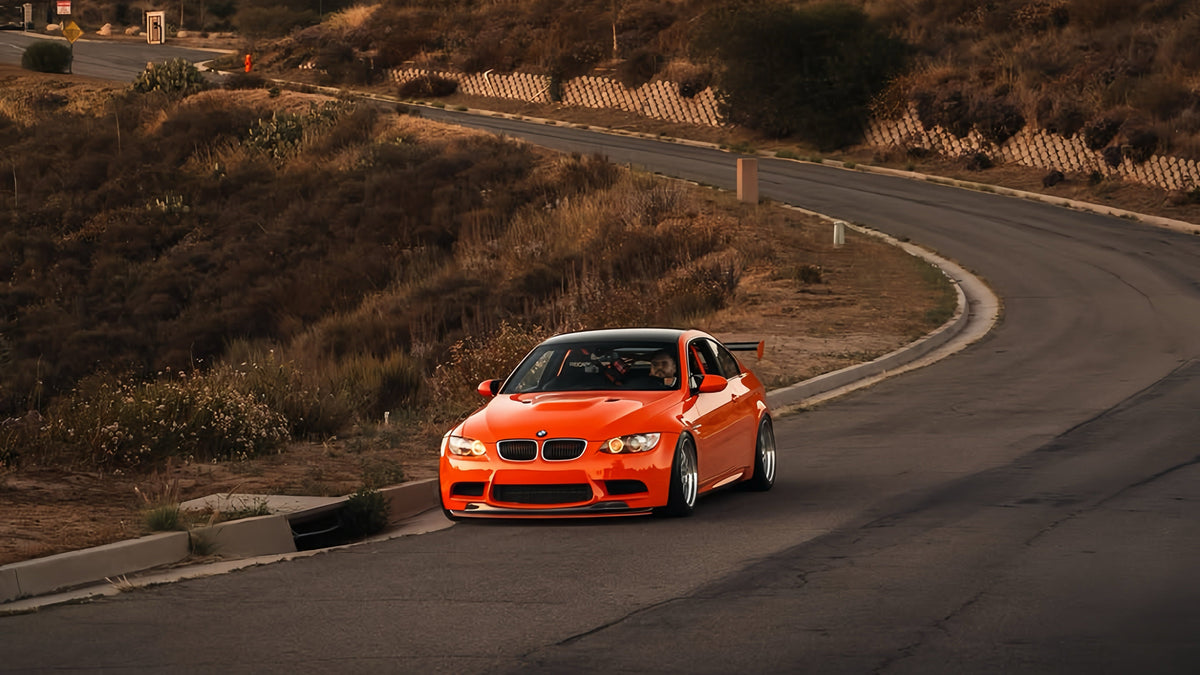 Fire Orange BMW E92 M3 GTS tribute build with carbon fiber front splitter and GT4 MK2 rear wing