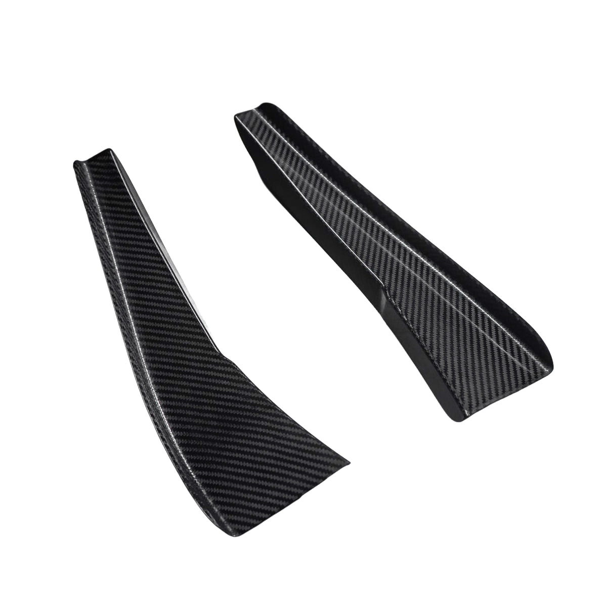 Pair of AlpineX Dynamics GT4 style carbon fiber canards for BMW E9X M3, shown at an angle on white with tapered shapes, raised edges and glossy woven surfaces