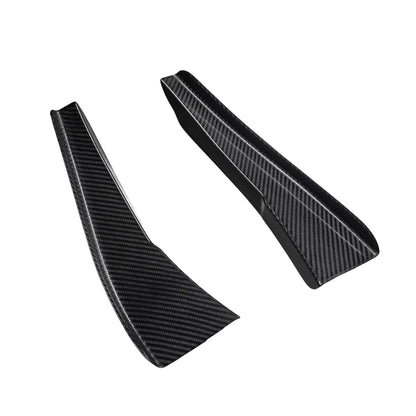 Pair of AlpineX Dynamics GT4 style carbon fiber canards for BMW E9X M3, shown at an angle on white with tapered shapes, raised edges and glossy woven surfaces