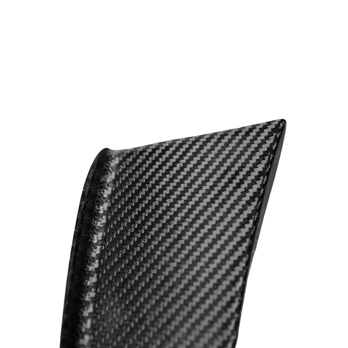 Detail of the tapered tip and raised edge of an AlpineX Dynamics GT4 style carbon fiber canard for BMW E9X M3, showing its glossy woven finish on white