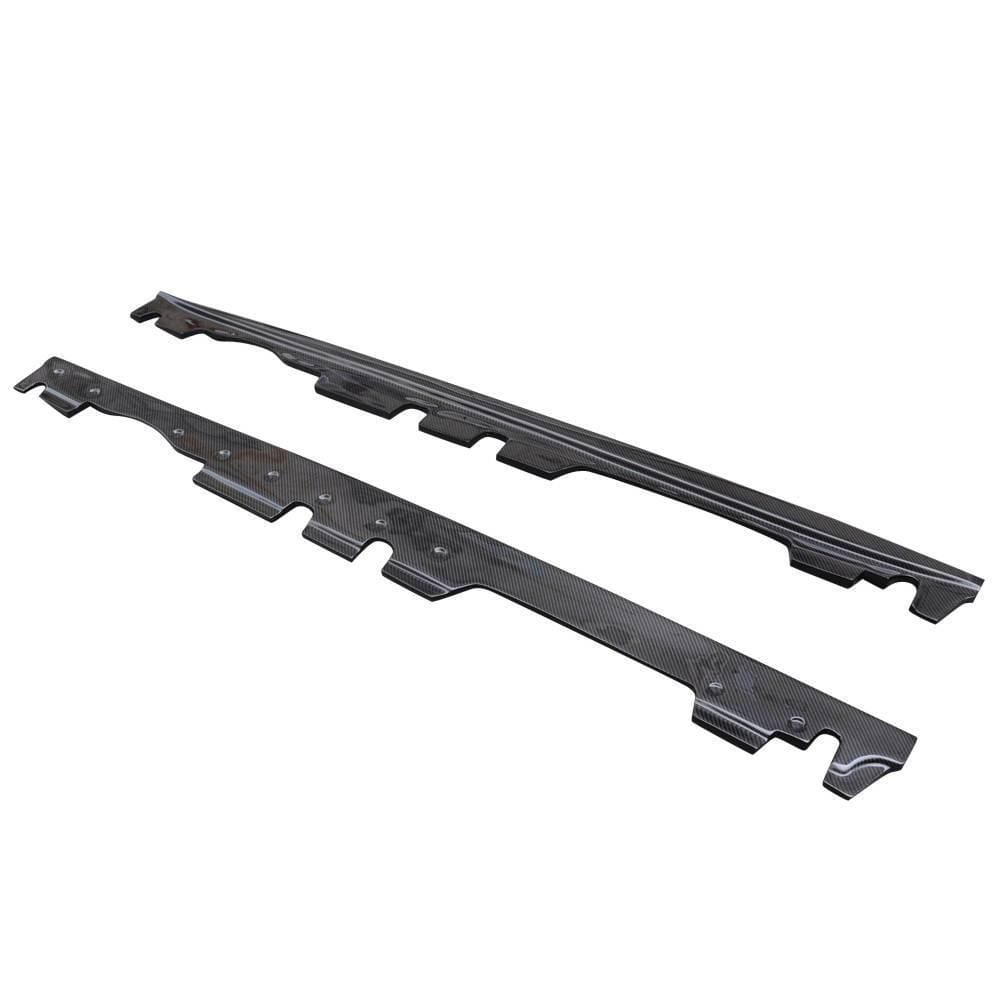 AlpineX Dynamics MP style carbon fiber side skirts for the BMW E9X M3, showing the upper profile and underside mounting holes on a white background