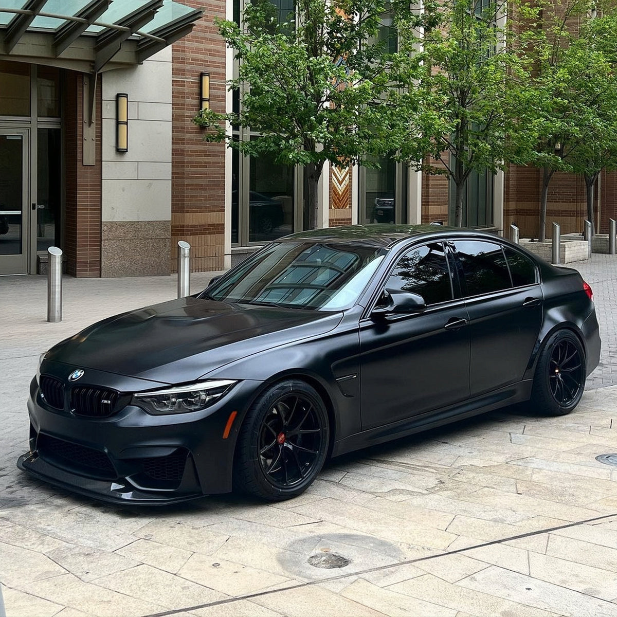Black BMW F80 M3 with adjustable GTS-style carbon fiber front splitter installed