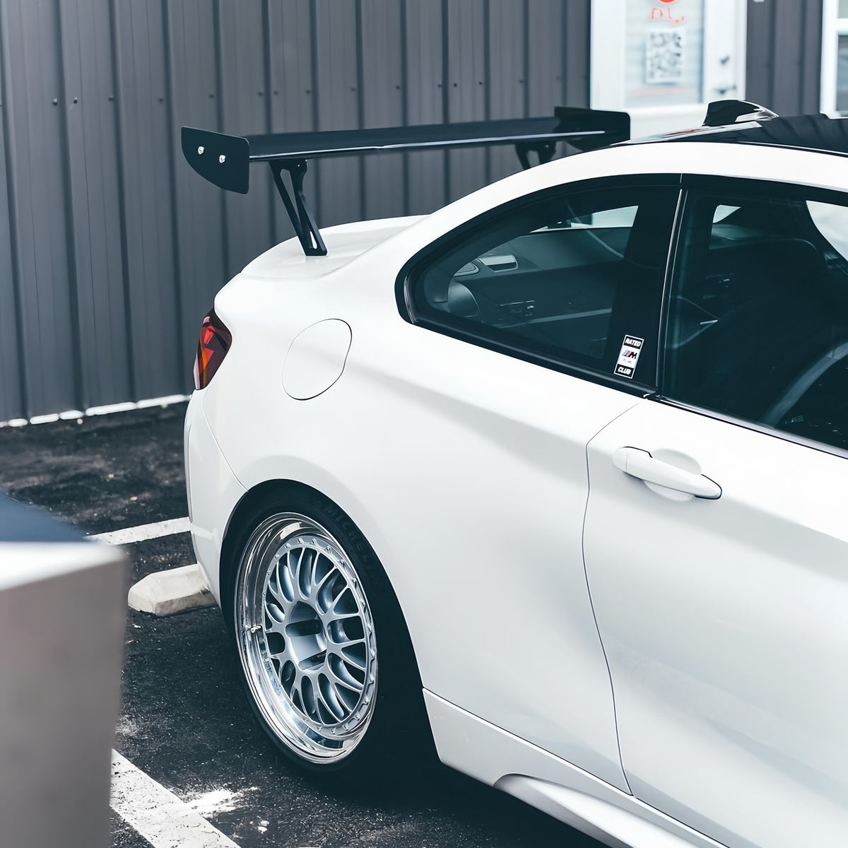 Side detail of M235iR carbon fiber rear wing installed on BMW F87 M2