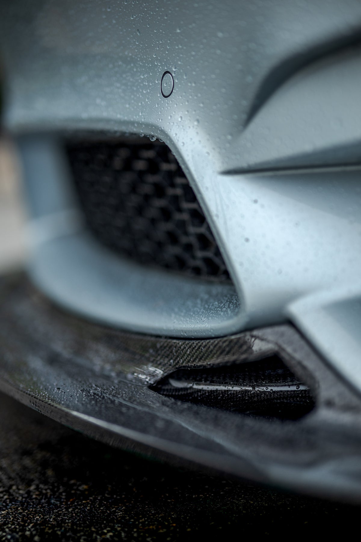 Close-up of the integrated brake cooling duct on the BMW F8X GT4 V2 front splitter