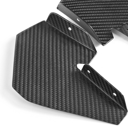 Close-up of the four BMW M4 GT4-based carbon fiber canards showing their vehicle-specific geometry