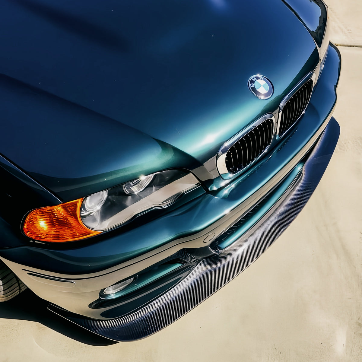 GT4 carbon fiber front lip installed on dark green BMW E46 M3