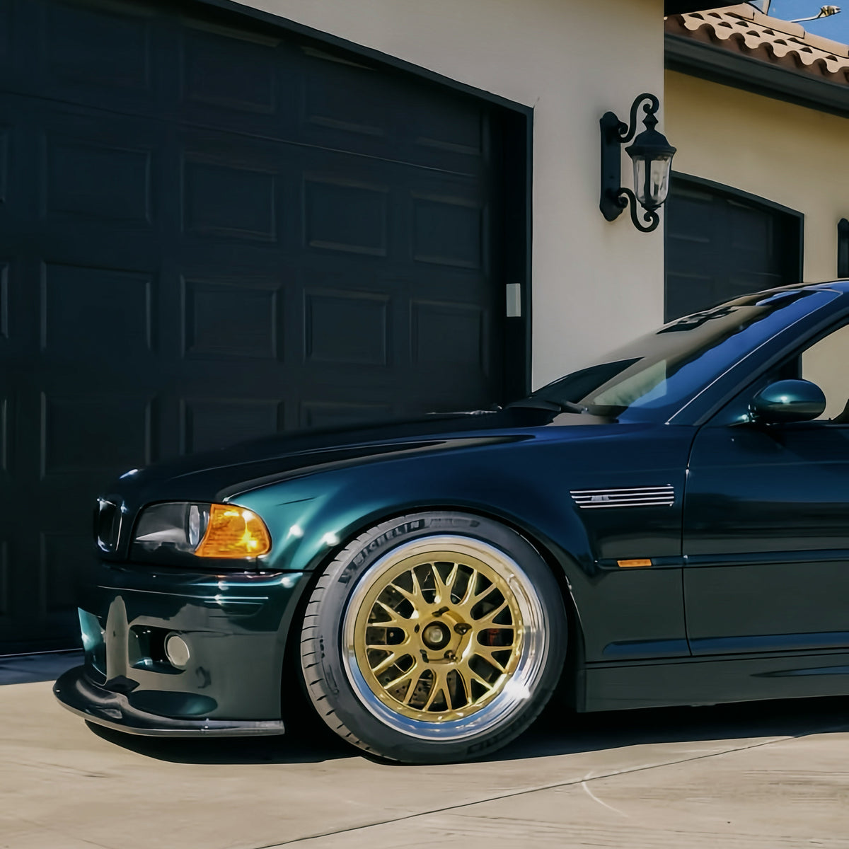 Dark green BMW E46 M3 showing GT4 carbon fiber front lip from the side