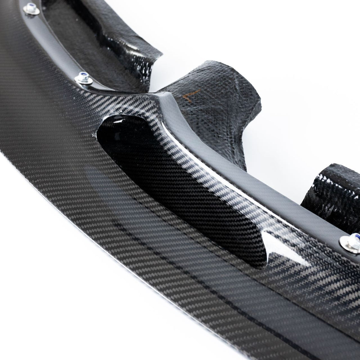 Close-up of the integrated carbon fiber brake cooling duct on the F8X GT4 V1 front splitter
