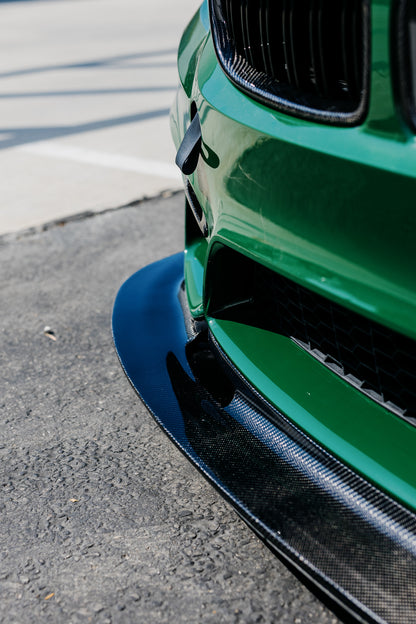 Side detail showing the approximately 4-inch extension of the F8X GT4 V2 front splitter