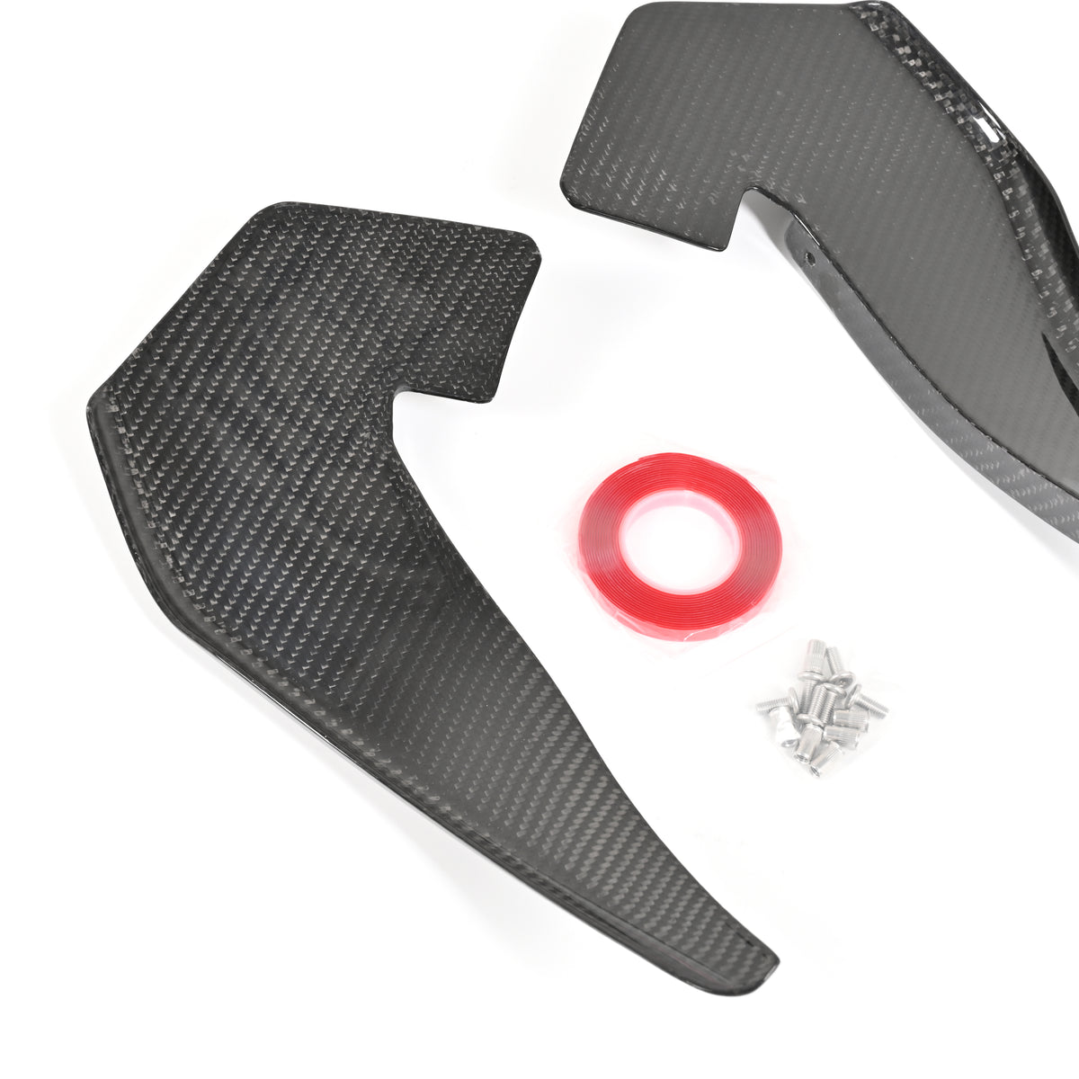 Two BMW G87 M2 carbon fiber canards shown with double-sided mounting tape and mechanical installation hardware