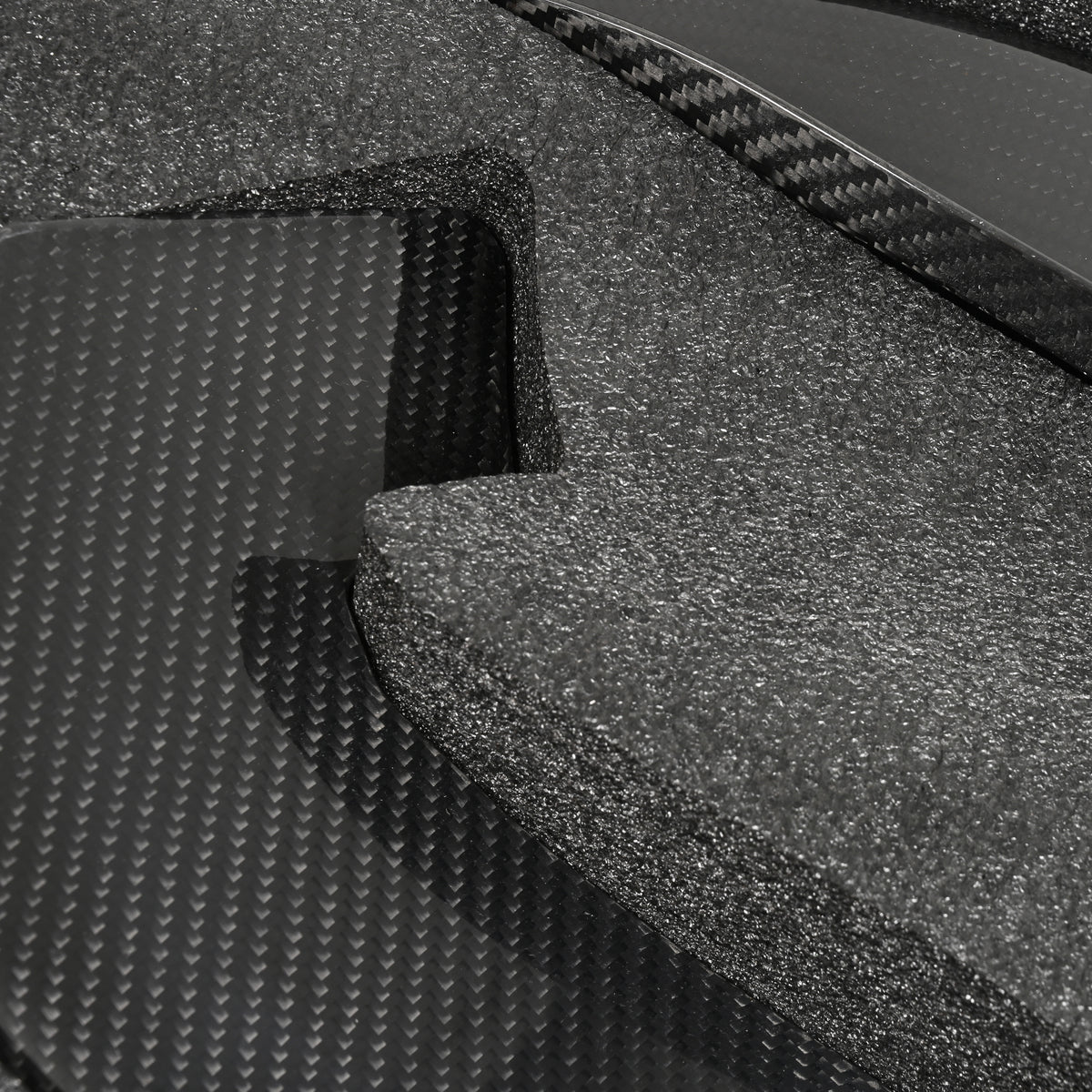 Close-up of the carbon fiber weave and contoured edge on a BMW G87 M2 GT4+ front bumper canard