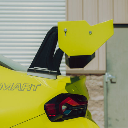 Close-up of the BMW G87 M2 GT4+ rear wing endplate, adjustment hardware and swan-neck upright