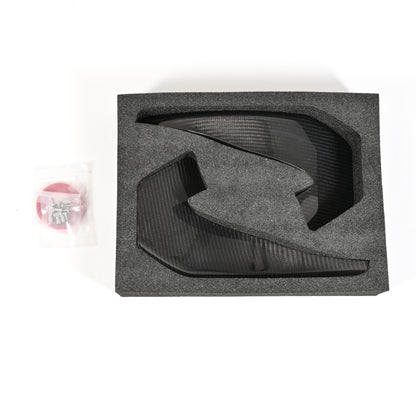 BMW G87 M2 GT4+ carbon fiber canards with mounting tape and hardware secured in protective foam packaging