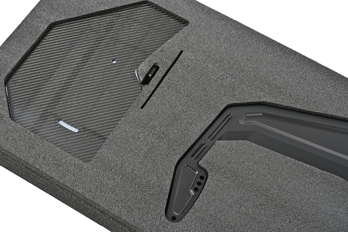 Close-up of a pre-preg carbon fiber endplate and swan-neck upright for the BMW G87 M2 GT4+ rear wing