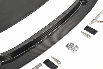 Close-up of the BMW G87 M2 GT4+ pre-preg carbon fiber front lip, skid blocks and installation hardware