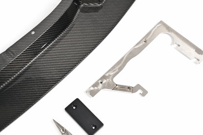 BMW G87 M2 GT4+ carbon fiber front lip with chassis-mounting bracket and skid block detail