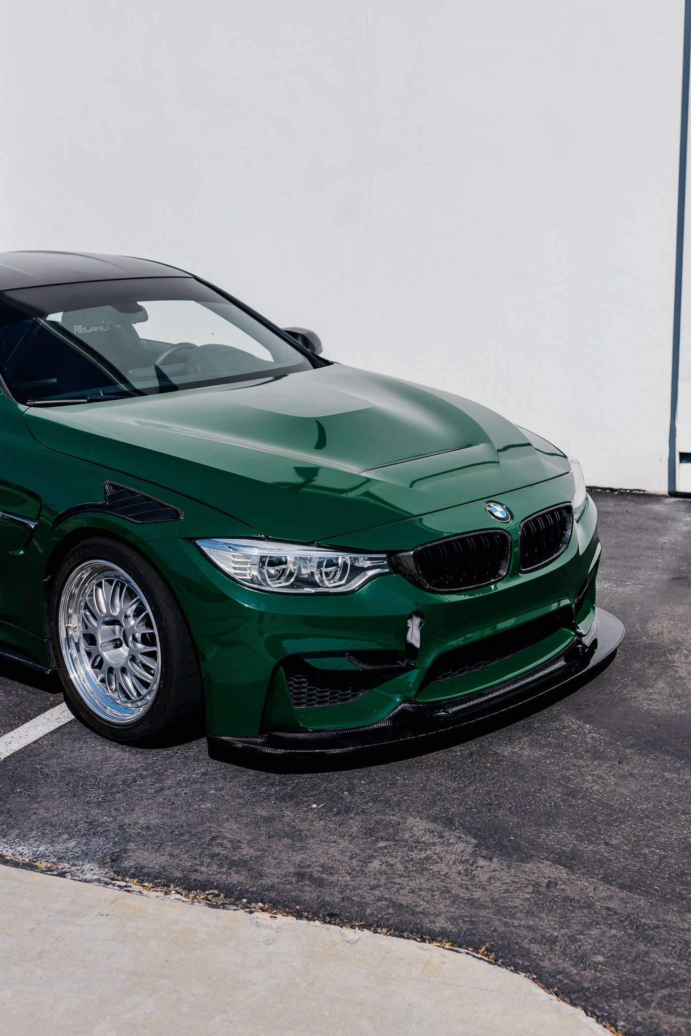 Green BMW F82 M4 fitted with the GT4 V2 longer carbon fiber front splitter