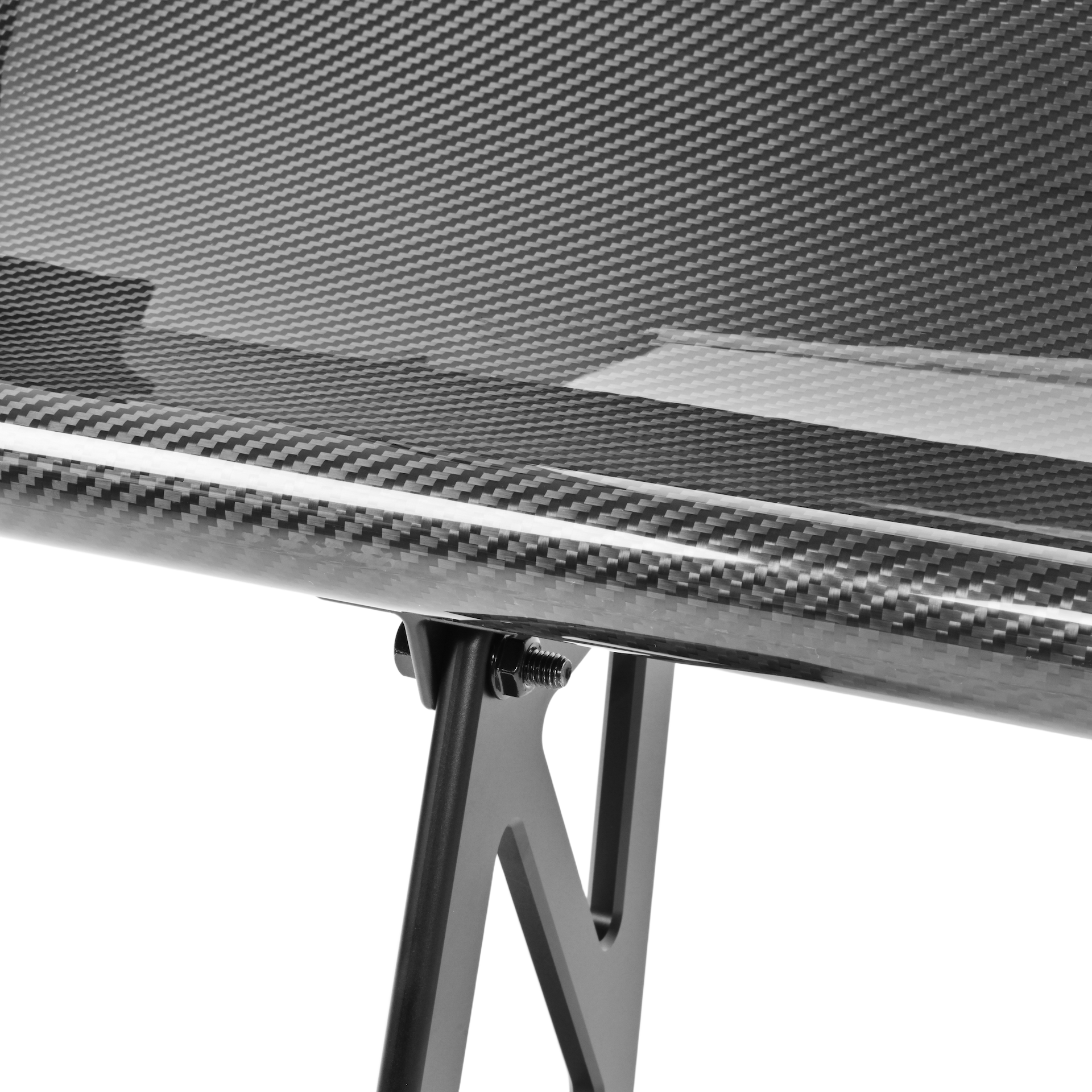 Close-up of the GT4+ pre-preg carbon fiber rear wing mainplane attached to an aluminum upright