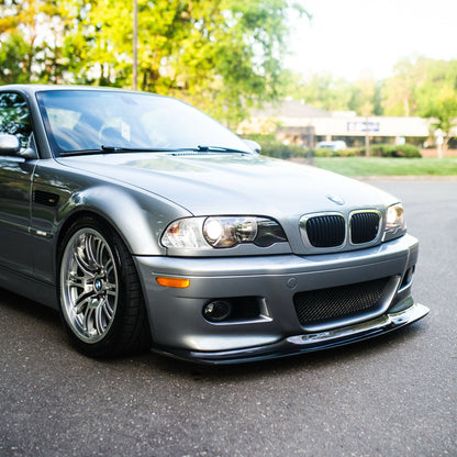 Silver BMW E46 M3 with carbon fiber GT4 front lip from front three-quarter angle