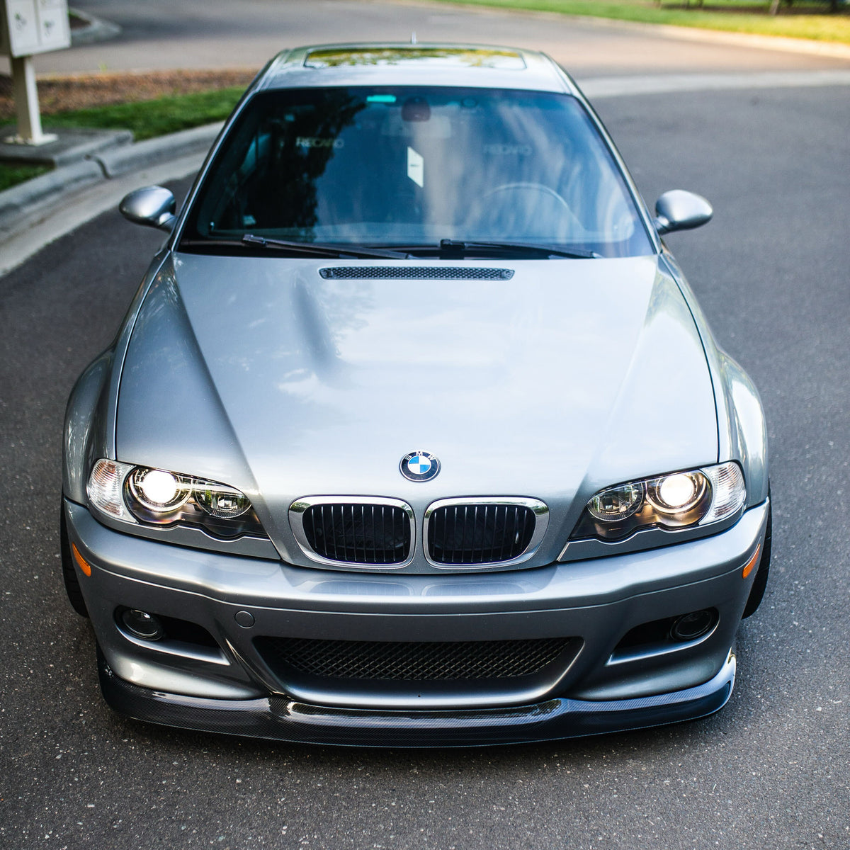 Front view of silver BMW E46 M3 with GT4 carbon fiber front lip
