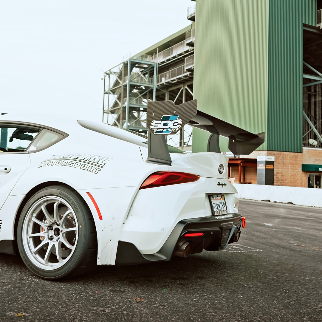 White Toyota GR Supra A90 with RM Engineering GT4+ carbon fiber rear wing installed