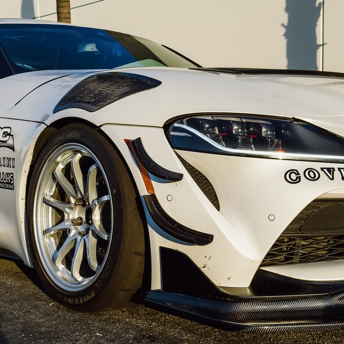 Toyota GR Supra A90 with four-piece GT4+ carbon fiber canards installed on the front bumper