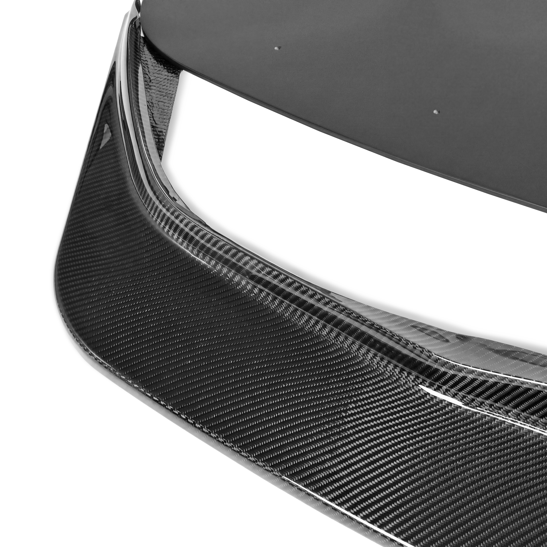 Close-up of the carbon fiber weave and leading edge on the Toyota GR Supra GT4+ front lip and splitter