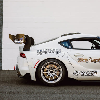 Side view of a Toyota GR Supra showing the GT4+ RS Roof Fin and rear wing configuration